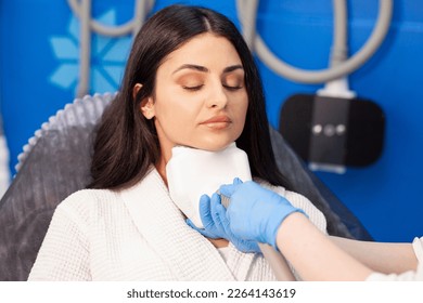coolsculpting procedure in cosmetology clinic, cosmetologist doctor makes procedure for removing fat from the chin to patient
