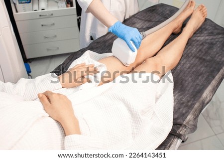 coolsculpting procedure in cosmetology clinic, doctor cosmetologist makes procedure for removing fat from the knee to patient