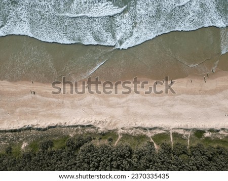 Coolum Beach, Sunshine Coast,Brisbane Queensland,aerial view,the sea shore with braking waves and white foamy summer background,Aerial beach top view over with people walking on the beach.