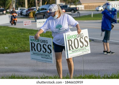 Cooper City, FL / United States - November 3, 2020: Campaign Worker Places Signs At A Polling Place