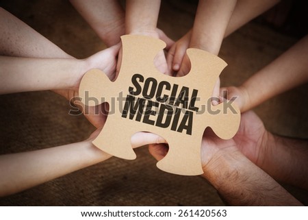 Cooperation - Jigsaw Puzzles in Teams Hands with social media on it