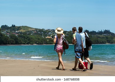 COOPERS BEACH, NZ - DEC 21 2013:Visitors on coopers beach in Doubtless Bay.It's a famous holiday travel destination in Northland  in the North Island of New Zealand.