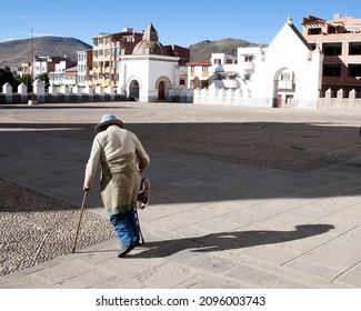 Copa Cabana, Bolivia, June 2015, Bolivian Man With Canes In Town Square