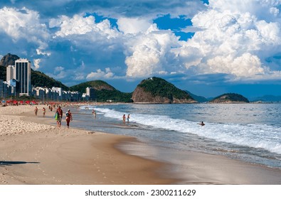 Copacabana beach and mountain Sugarloaf in Rio de Janeiro, Brazil. Copacabana beach is the most famous beach in Rio de Janeiro. Sunny cityscape of Rio de Janeiro
