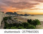 Copacabana Beach and Sugar Loaf Mountain at sunrise, Rio de Janeiro. Dramatic sky with orange colors