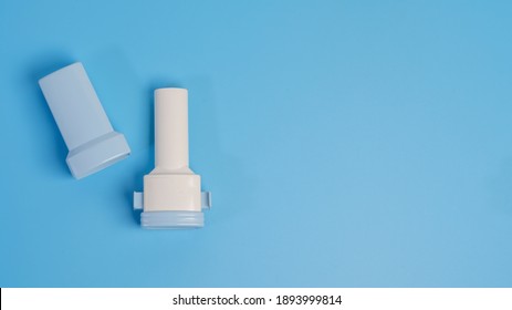 COPD Or Asthma Medication Instruments A Capsule Inhaler .On Blue Background.