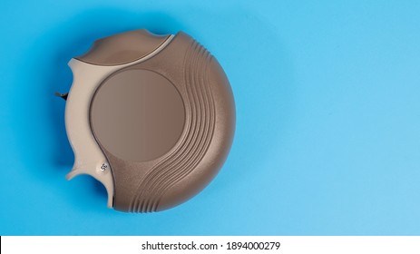 COPD Or Asthma Medication Instruments ,discus Inhaler.On Blue Background.