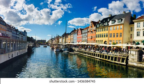 COPENAGHEN, DENMARK - JUNE 2019: Panoramic view of Nyhavn the Copenaghen city center Canal with his colorful traditional houses