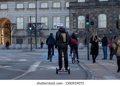 Copenhagen - 19. March 2019: Man Cruising Through Copenhagen's Streets On A Mini Segway.