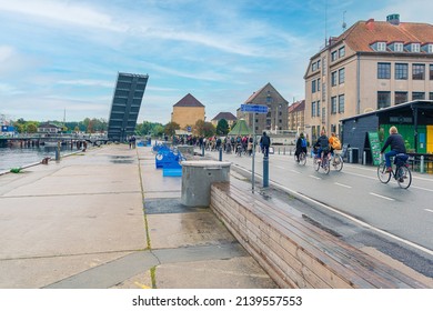 Copenhagen, Denmark - 10.20.2021: A big queue of cyclists stands near raised crossings of Butterfly 3-Way Bridge - lightweight foot and cycle bridge in copenhagen, Denmark