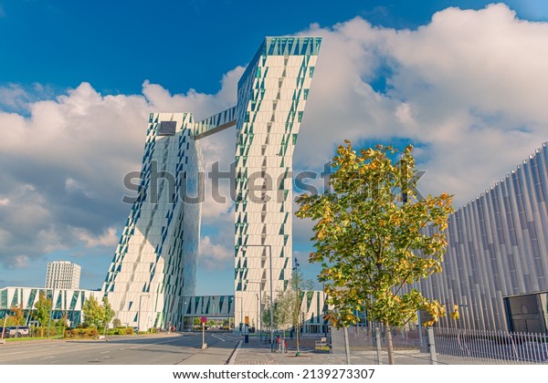 Copenhagen, Denmark - 10.20.2021: Two\
towers of modern AC Hotel Bella Sky and Bella exhibition and\
conference Center in the Ørestad district of Copenhagen,\
Denmark