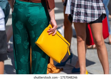 COPENHAGEN, DENMARK - AUGUST 11 2018: Street Style During Copenhagen Fashion Week Spring Summer 2019. Outfit: Green Silk Pants And Yellow Loewe Bag