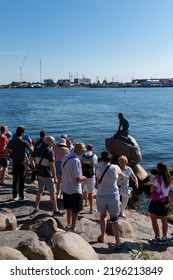 Copenhagen, Denmark. August 13, 2022. A Group Of Tourists Next To The Little Mermaid Statue (Den Lille Havfrue) In Early Summer Morning