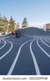 Copenhagen, Denmark, August 2021-Man Running With The Pram At Superkilen Park In Copenhagen City Center