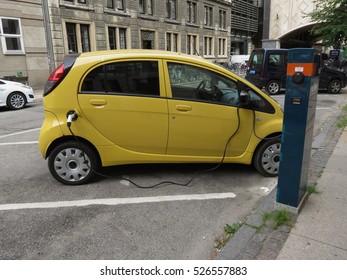 COPENHAGEN, DENMARK - CIRCA JUNE 2016: yellow Mitsubishi electric car recharging on the street