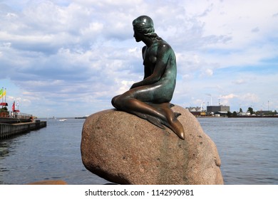 COPENHAGEN, DENMARK - JULY 12, 2018: The little mermaid statue on Langelinie promenade in Copenhagen, Denmark