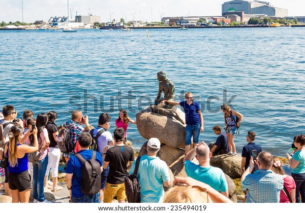 COPENHAGEN, DENMARK - JULY 25: The Little Mermaid, a\
bronze sculpture by Edvard Eriksen. Major tourist attractions in\
Copenhagen on July 25,\
2014