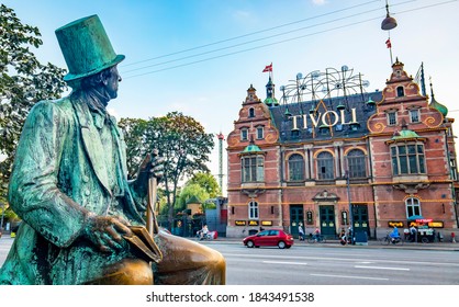 Copenhagen, Denmark - June 19, 2020: Hans Christian Andersen sculpture and Tivoli Garden amusement park in central Copenhagen