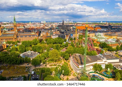 COPENHAGEN, DENMARK - JUNE 2019 - Aerial View Of The Tivoli Gardens Amusement Park With People, Visitors, Attractions And Rides. Urban View Of The City Of Copenhagen In Denmark, Europe