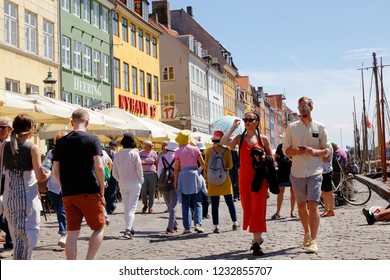 Copenhagen, Denmark - June 27, 2018: People Strolling In The Nyhavn District.