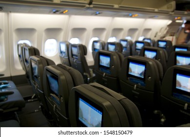 COPENHAGEN, DENMARK - NOV 24th, 2018: Empty Airplane Seats Waiting For Passengers And Take Off In An Airplane. Empty Plane Interior Before Flight And Departure. Watching Movie On An Aircraft