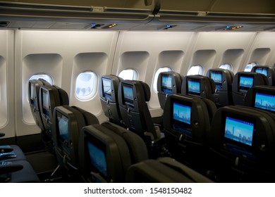 COPENHAGEN, DENMARK - NOV 24th, 2018: Empty Airplane Seats Waiting For Passengers And Take Off In An Airplane. Empty Plane Interior Before Flight And Departure. Watching Movie On An Aircraft