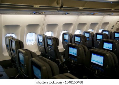 COPENHAGEN, DENMARK - NOV 24th, 2018: Empty Airplane Seats Waiting For Passengers And Take Off In An Airplane. Empty Plane Interior Before Flight And Departure. Watching Movie On An Aircraft