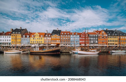 COPENHAGEN, DENMARK, SEPTEMBER 17, 2021: Copenhagen iconic view. Famous old Nyhavn port in the center of Copenhagen, Denmark during winter sunny day