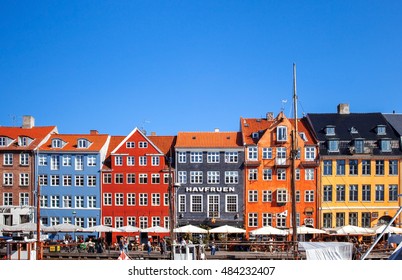 COPENHAGEN, DENMARK - SEPTEMBER 9: people in open cafes of the famous Nyhavn promenade on September 9, 2016 in Copenhagen, Denmark. Nyhavn is one of the most famous landmark of Copenhagen.
