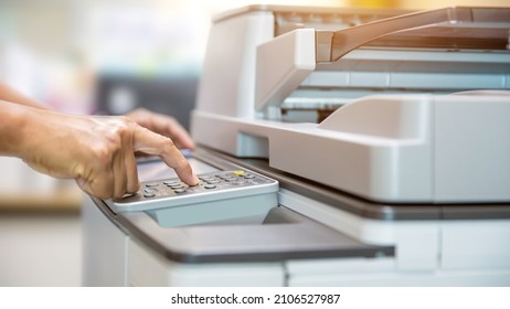 Copier printer, Close up hand office man press copy button on panel to using the copier or photocopier machine for scanning document printing a sheet paper and xerox photocopy. - Shutterstock ID 2106527987