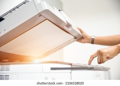 Copier printer, Close up hand office man press copy button on panel to using the copier or photocopier machine for scanning document printing a sheet paper and xerox photocopy. - Shutterstock ID 2106528020