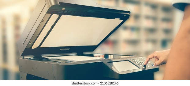 Copier printer, Close up hand office man press copy button on panel to using the copier or photocopier machine for scanning document printing a sheet paper and xerox photocopy. - Shutterstock ID 2106528146