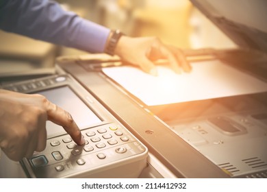 Copier printer, Close up hand office man press copy button on panel to using the copier or photocopier machine for scanning document printing a sheet paper and xerox photocopy.