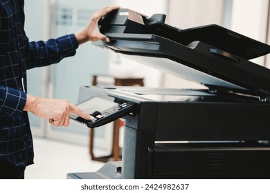 Copier printer, Close up hand office man press copy button on panel to using the copier or photocopier machine for scanning document printing a sheet paper.