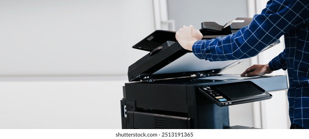 Copier printer, Close up hand office man press copy button on panel to using the copier or photocopier machine for scanning document printing a sheet paper.