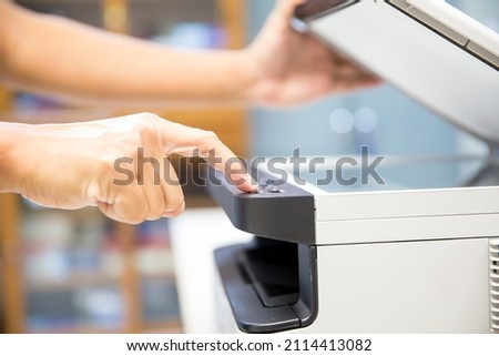 Copier printer, Close up hand office man press copy button on panel to using the copier or photocopier machine for scanning document printing a sheet paper and xerox photocopy.