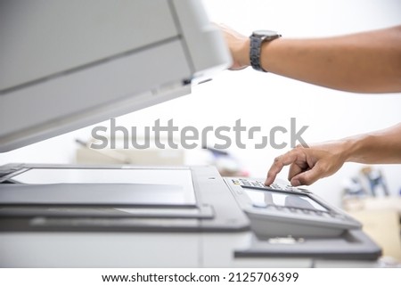Copier printer, Close up hand office man press copy button on panel to using the copier or photocopier machine for scanning document printing a sheet paper and xerox photocopy.