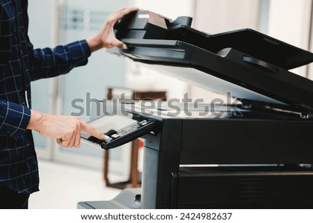 Copier printer, Close up hand office man press copy button on panel to using the copier or photocopier machine for scanning document printing a sheet paper.