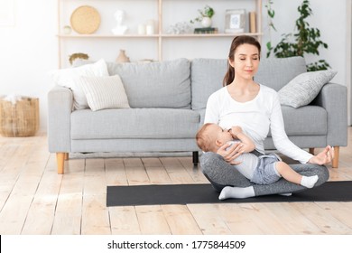 Coping With Motherhood Stress. Young Mom Breastfeeding Baby And Meditating At Home, Sitting In Lotus Position Of Floor, Copy Space