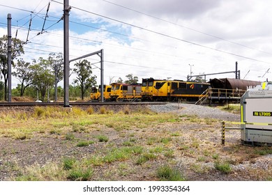 Coppabella, Queensland, Australia - February 2021; Four Parked Yellow Coal Train Engines Waiting For Shift Change At Coppabella.