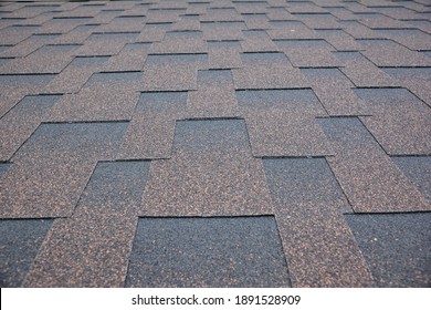 Copper Brown Roofing Asphalt Shingles Texture Background. A Close-up Of An Asphalt Laminated, Dimensional, Or Architectural Shingled Roof. Asphalt Shingles Roofing Construction.