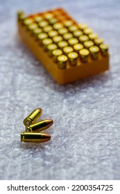 Copper Bullets Of Semi Automatic Pistol On Natural Light Background.