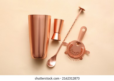 Copper Cobbler Shaker, Double Jigger, Strainer And Mixing Spoon On Color Background