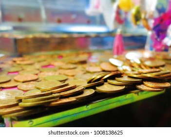 Copper Coins About To Fall In A Coin Pusher Machine At The Fairground