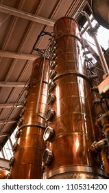 Copper Columns Stand Tall To Whiskey Still In An American Whiskey Distillery.