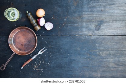 Copper Frying Pan On A Black Wooden Table, Cooking Background , Top View.