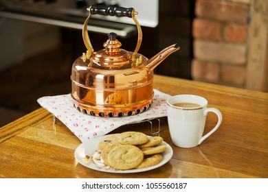 Copper kettle, tea and biscuits
