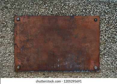 Copper Metal Nameplate Frame On Sandstone Wall