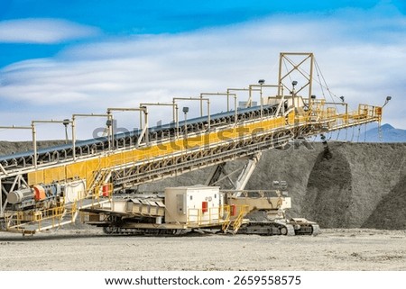 At a copper mine, a mobile conveyor system steadily builds a leaching pile, crucial for mineral recovery.