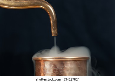 A Copper Pipe Of A Distillery With Steam.